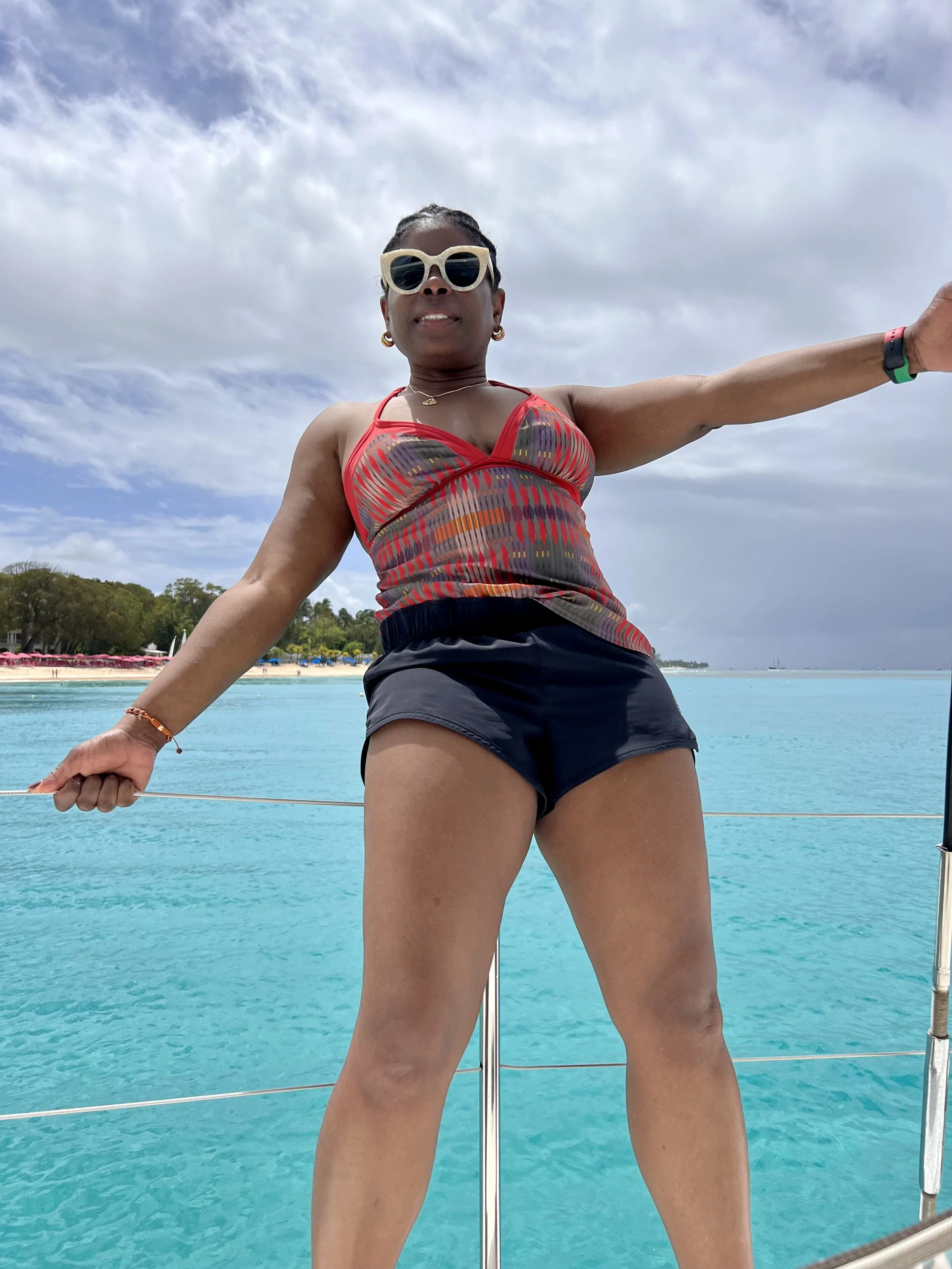 Meg Charles enjoying a beach moment representing freedom, success, and aligned living
