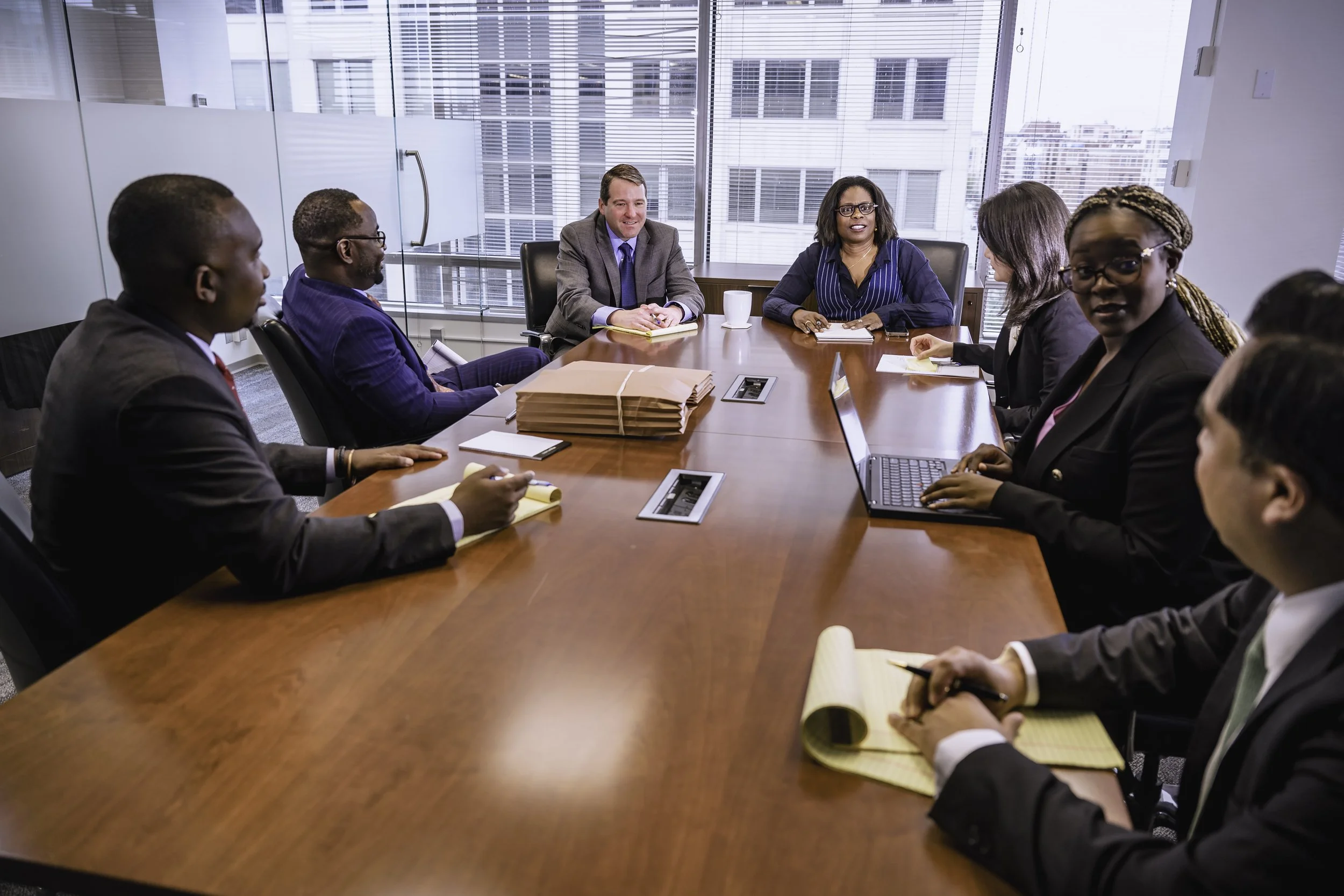 Corporate leadership meeting in a boardroom representing executive strategy and legal expertise