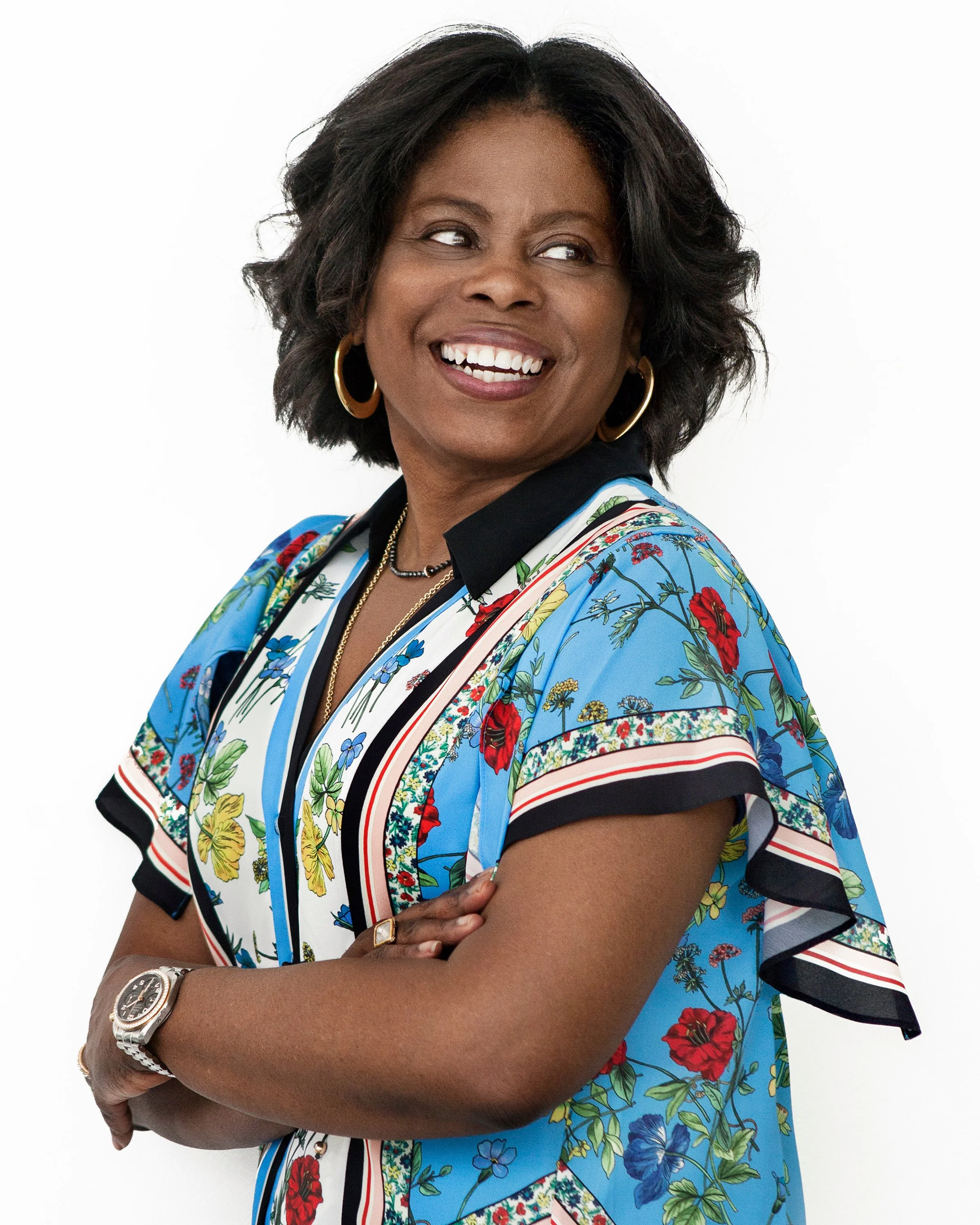 Meg Charles smiling portrait representing leadership, confidence, and personal alignment