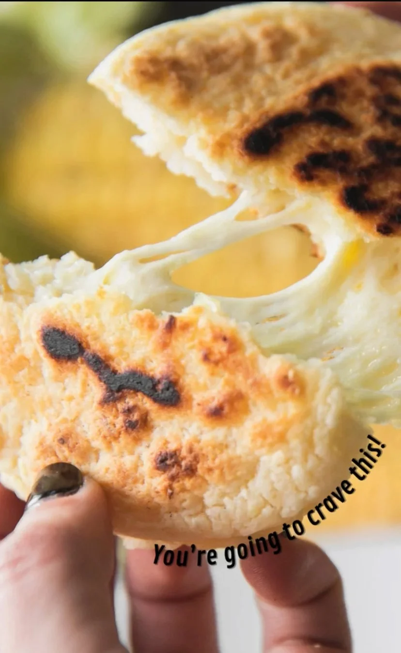 Close-up of melted cheese stretching from a toasted sandwich with visible grilled bread and melted cheese, with text overlay "You're going to crave this!".