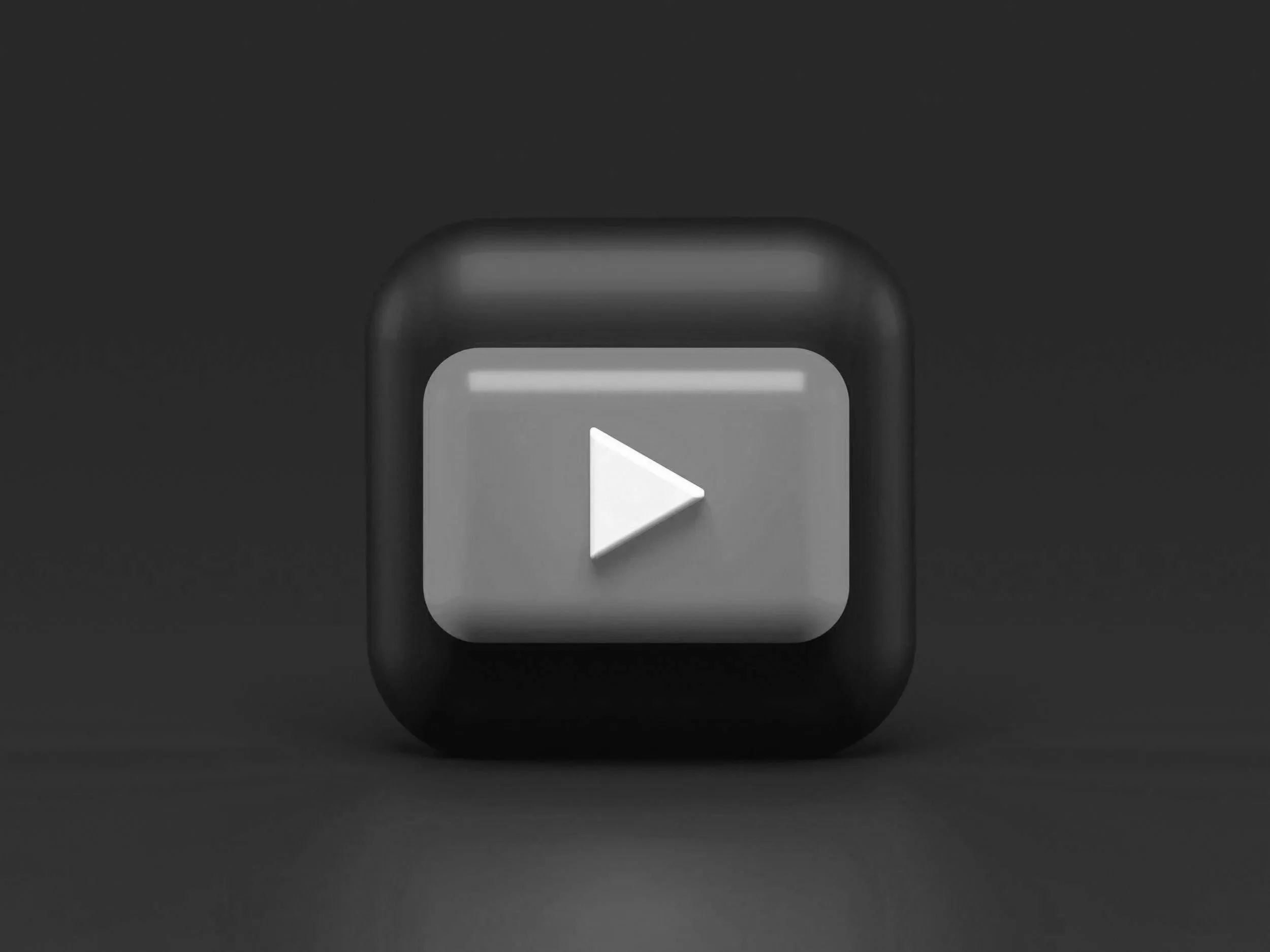 A black square icon with a white play button in the center, resembling a media play button.