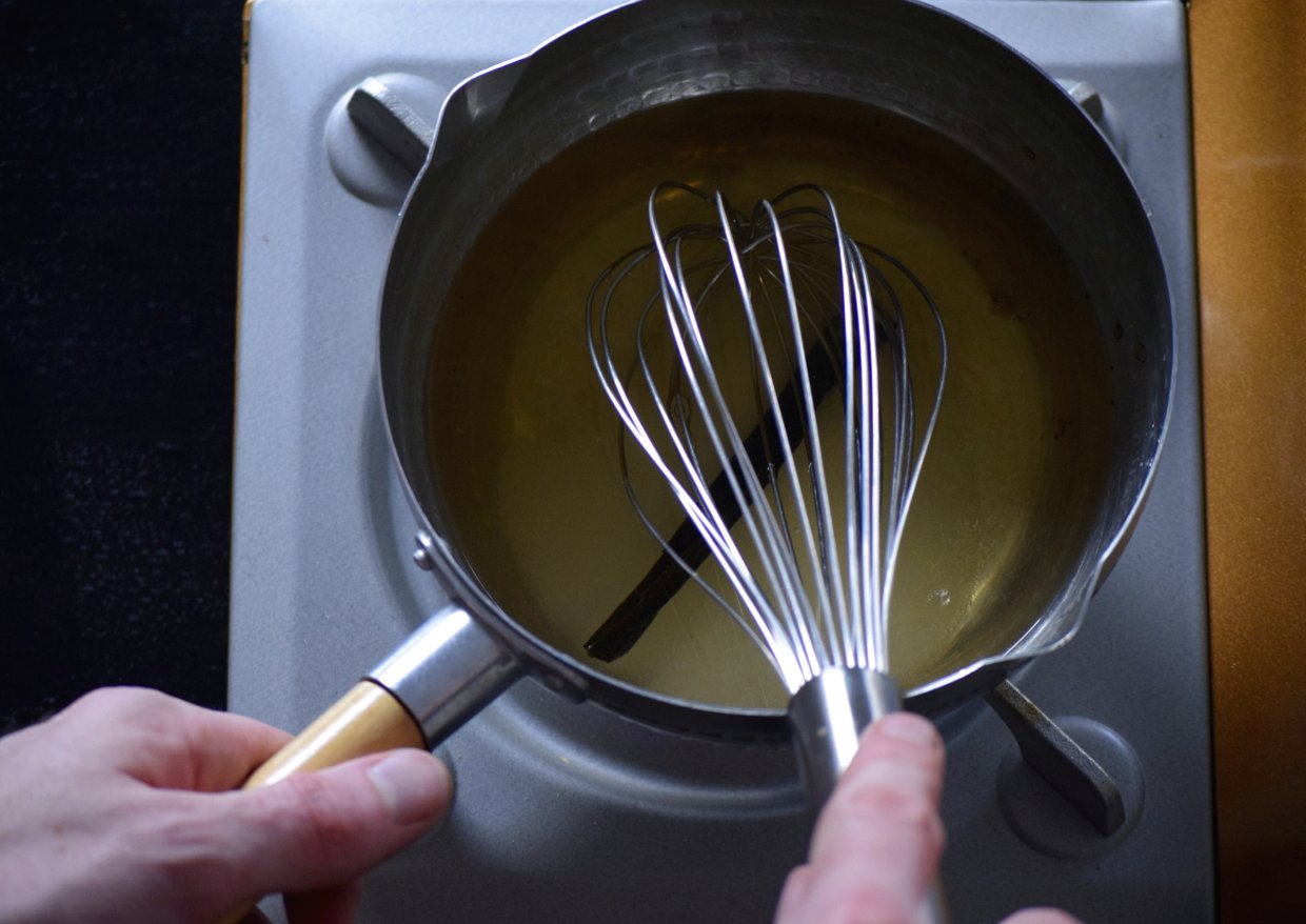 Japanese sushi vinegar heating gently with kombu in a saucepan