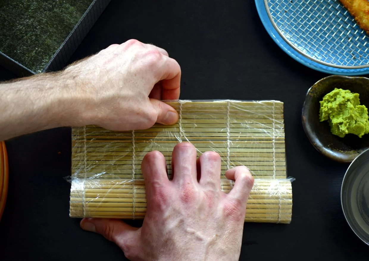 pinch the sushi mat and roll tighter the second time