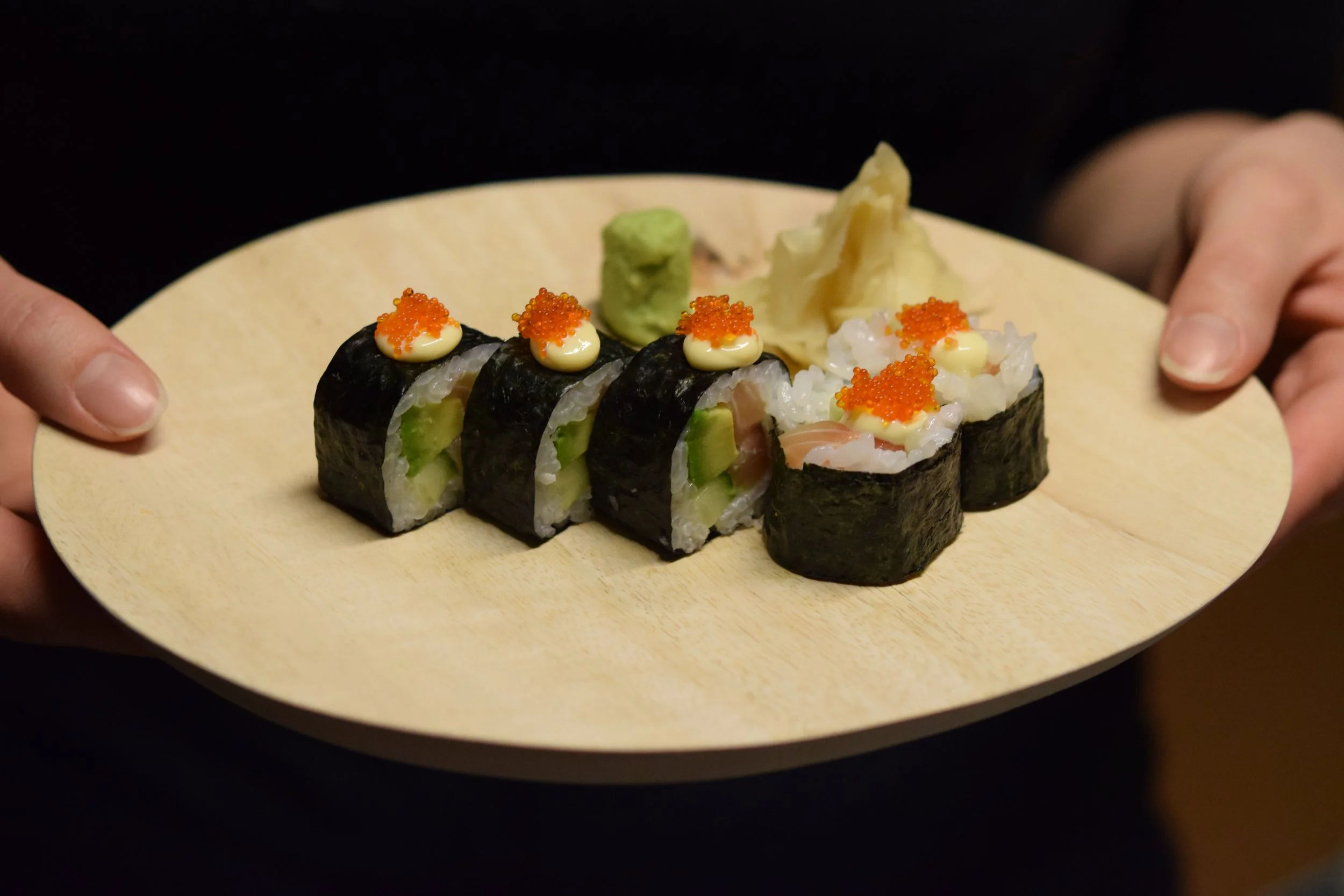 Sushi class student learning how to roll and present maki sushi