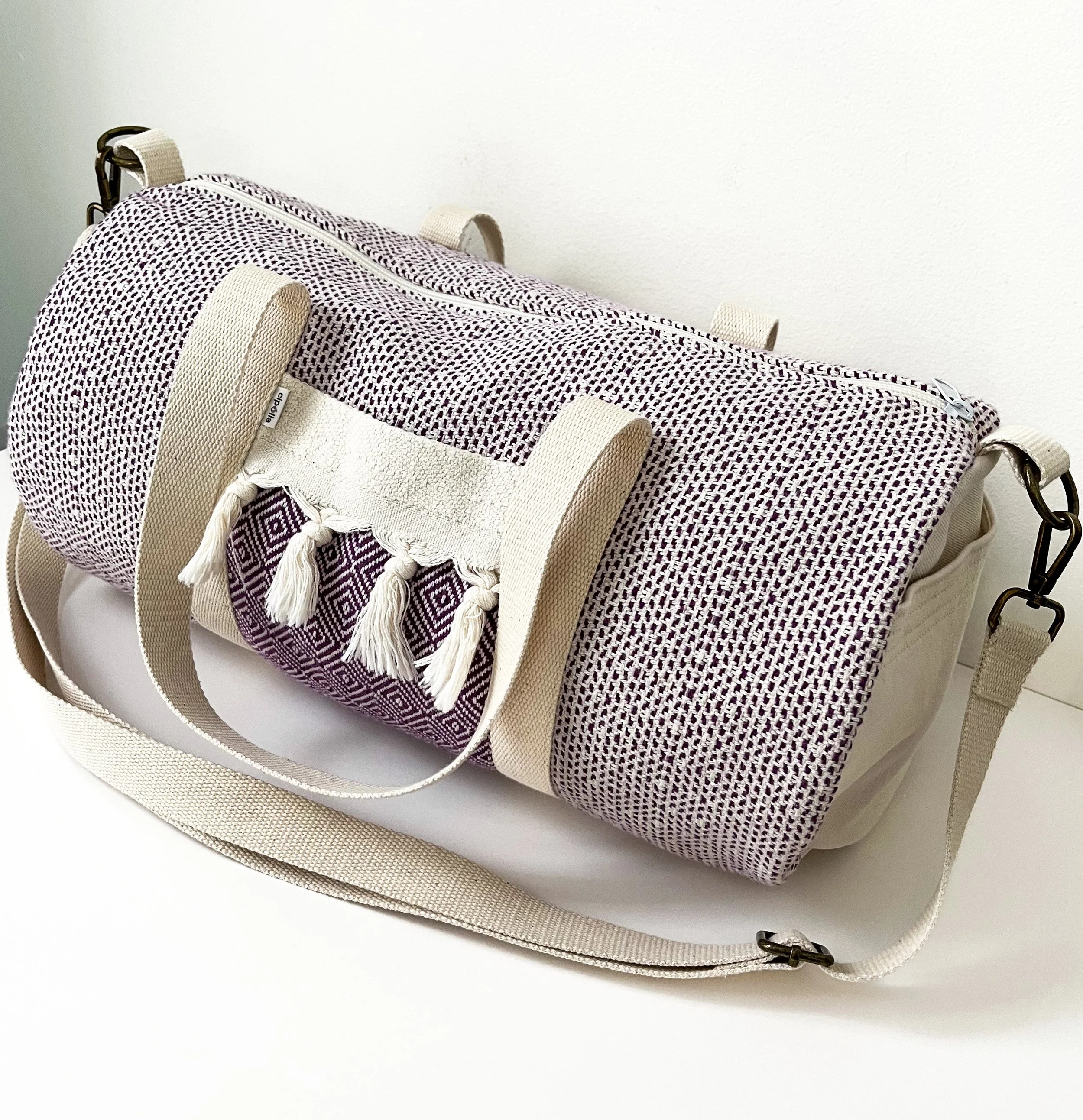 CipollaDuffleBag_CreamEggplant_Strap.jpg