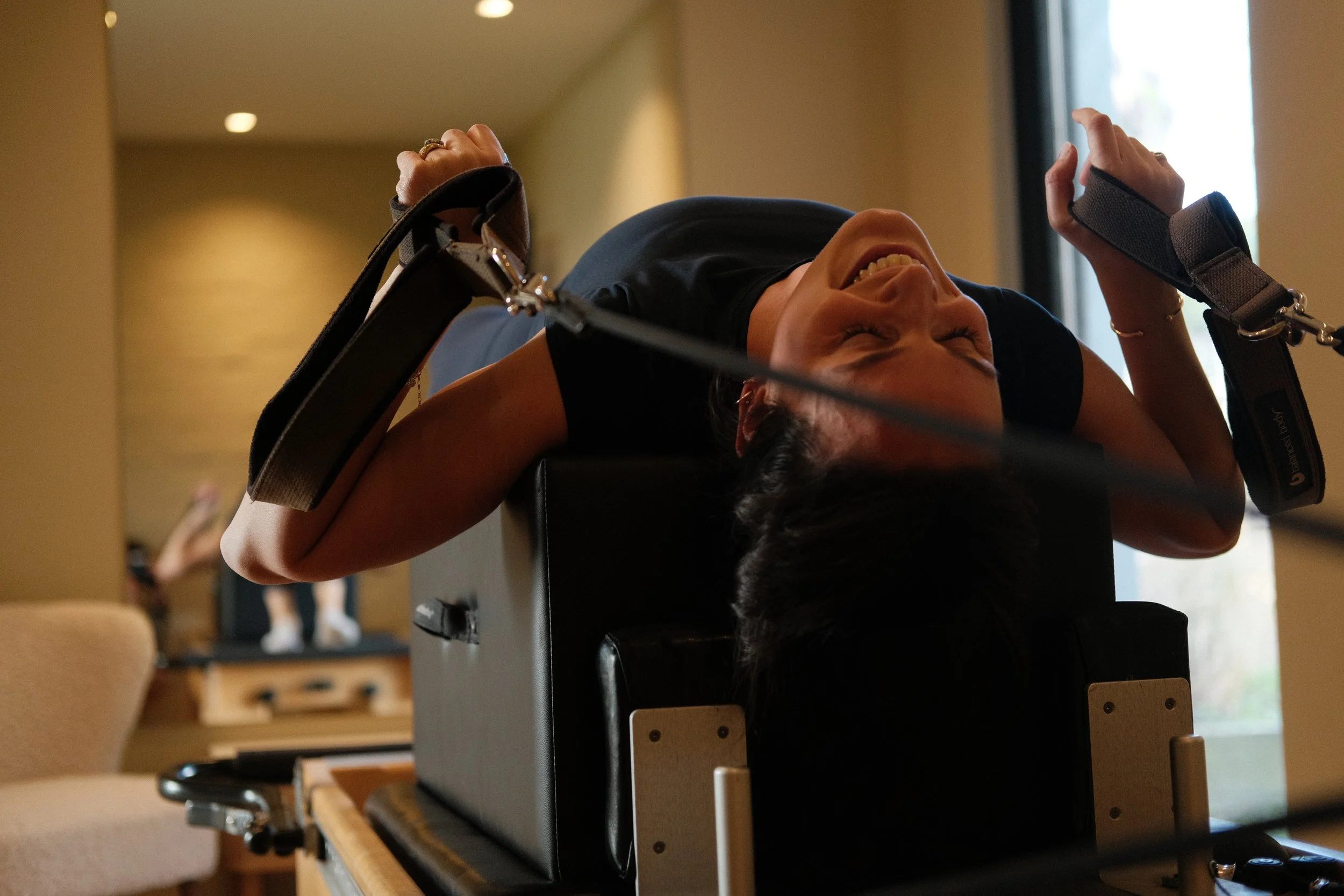 Rasheeda relaxes between repetitions on the Reformer.