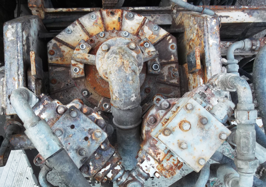 Close-up of rusty industrial machinery with pipes and metal components.