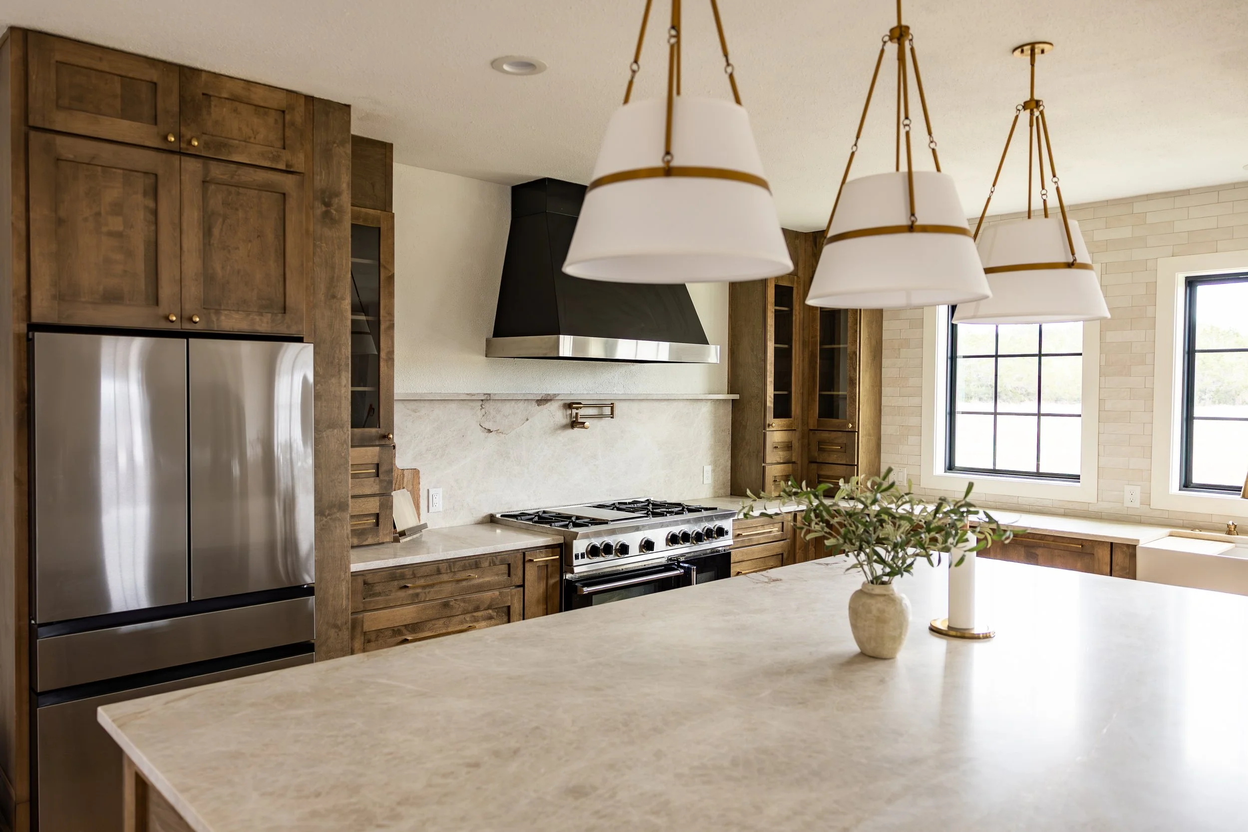 This luxury kitchen renovation features handcrafted cabinetry, a spacious oversized island, quartz surfaces, a custom vent hood, and high-end finishes throughout. Every detail was carefully selected to deliver a sophisticated, functional, and timeles