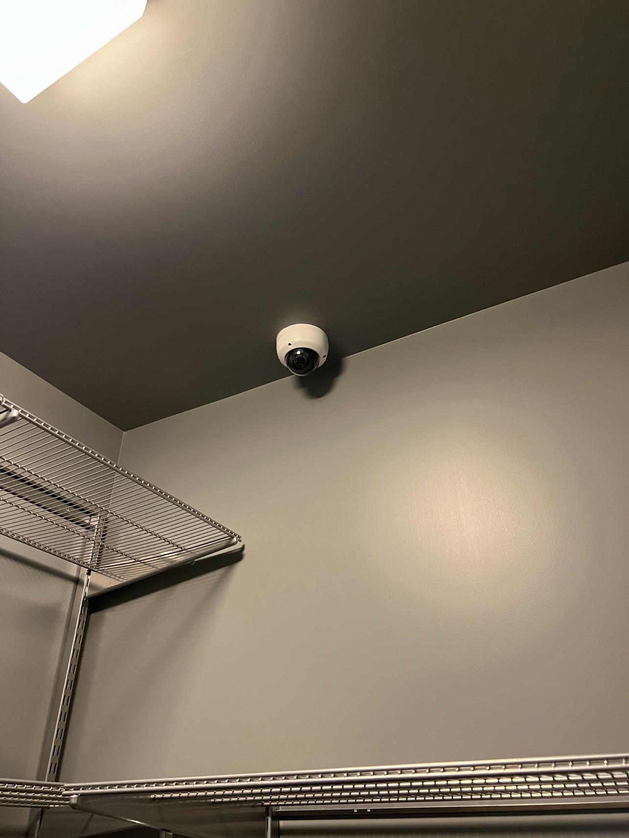 Security camera installed inside package room for 24/7 monitoring and theft prevention.