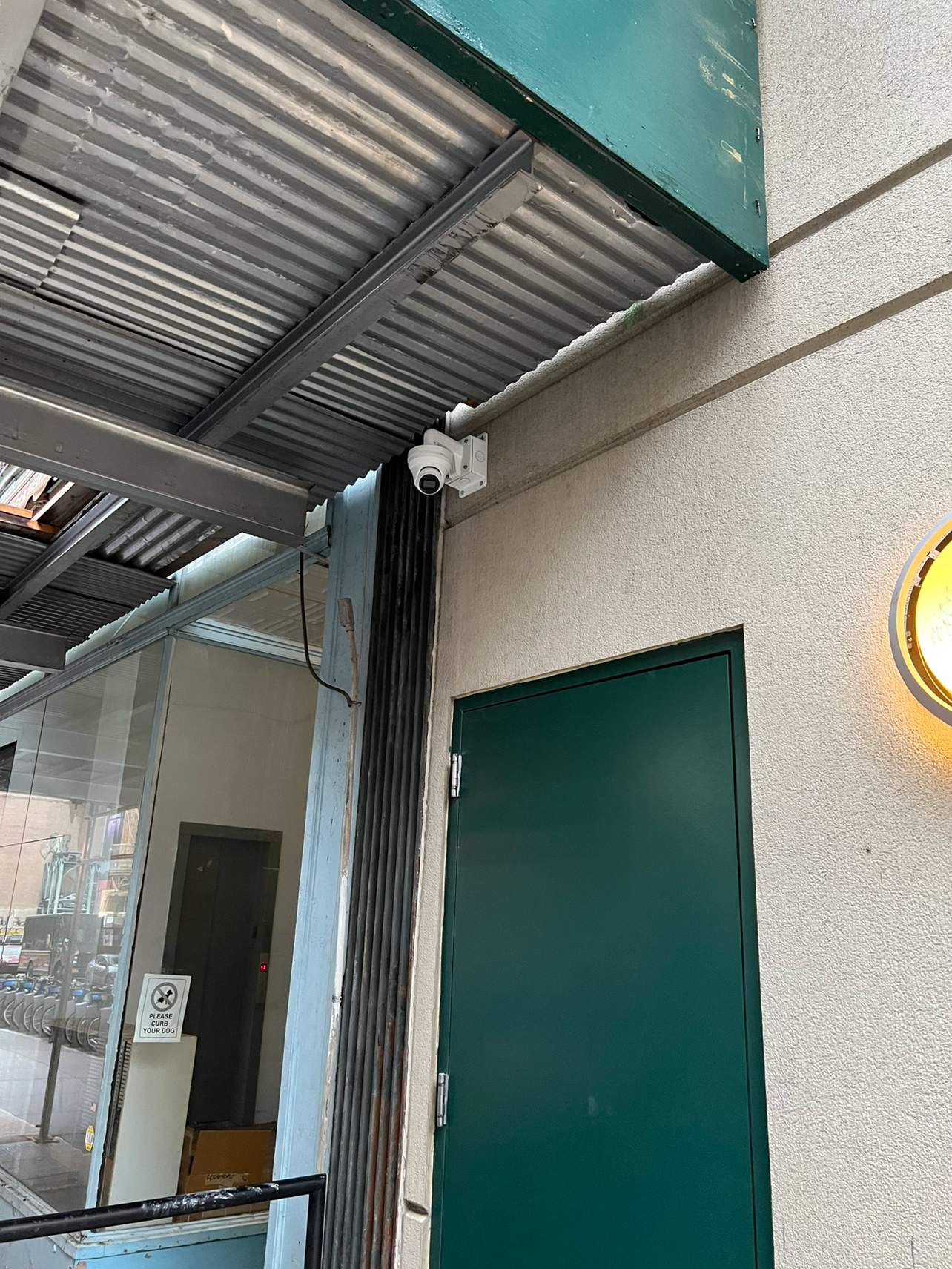 Outdoor security camera installation protecting a commercial property side entrance.