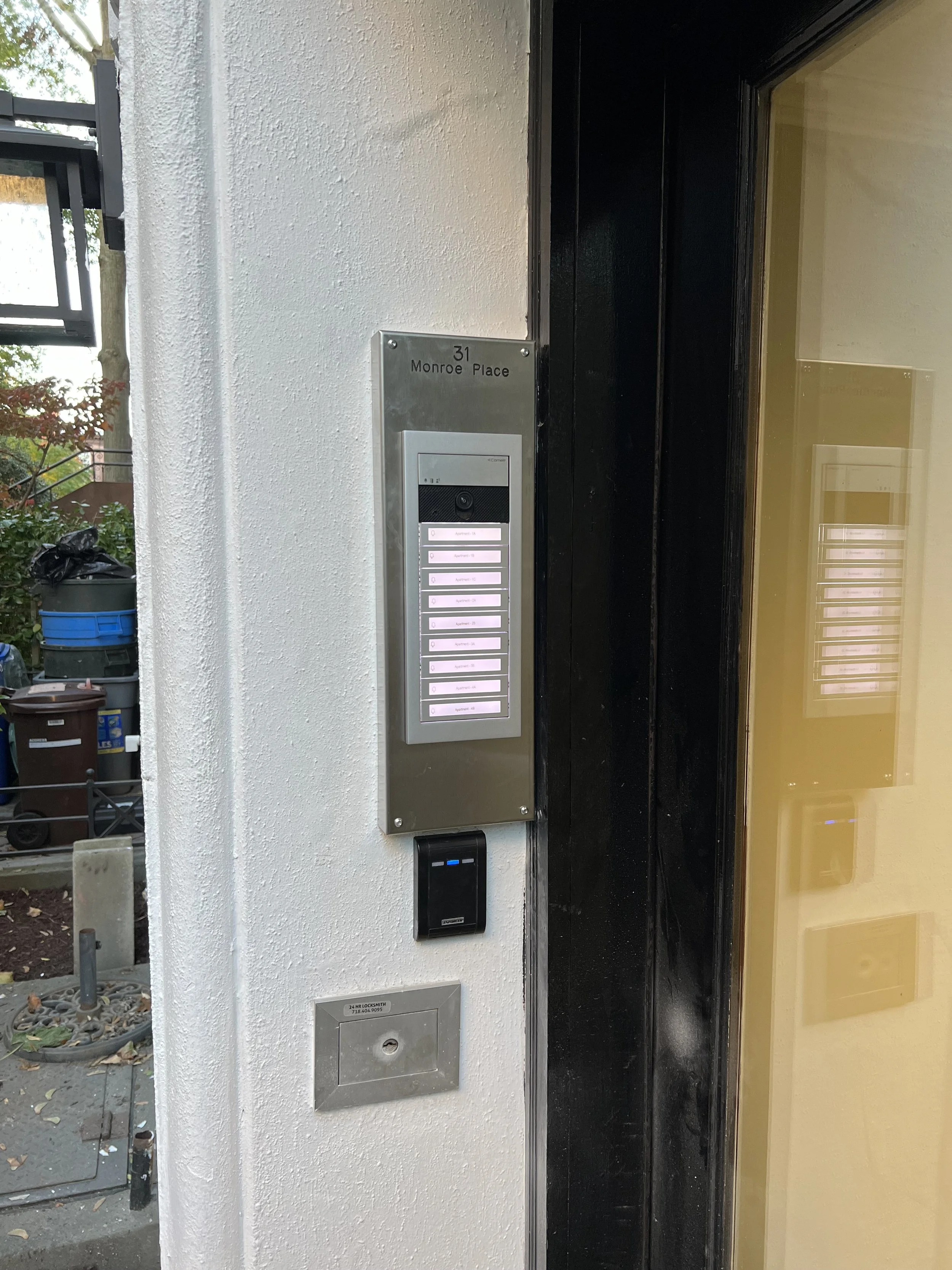 Apartment building entrance with a directory panel, doorbell, and a mailbox. The directory indicates the address 31 Monroe Place.
