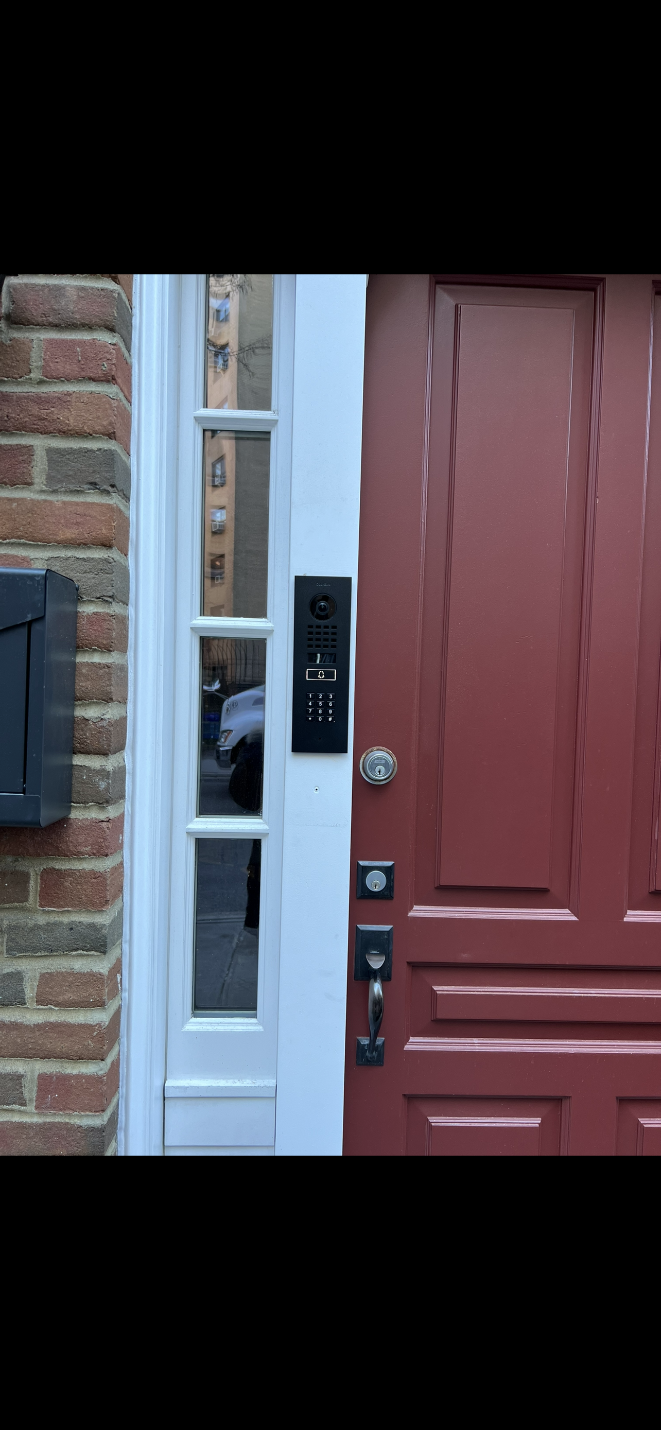 DoorBird video intercom installed at exterior entrance for visitor communication and access in NYC - Impera Security Systems. 