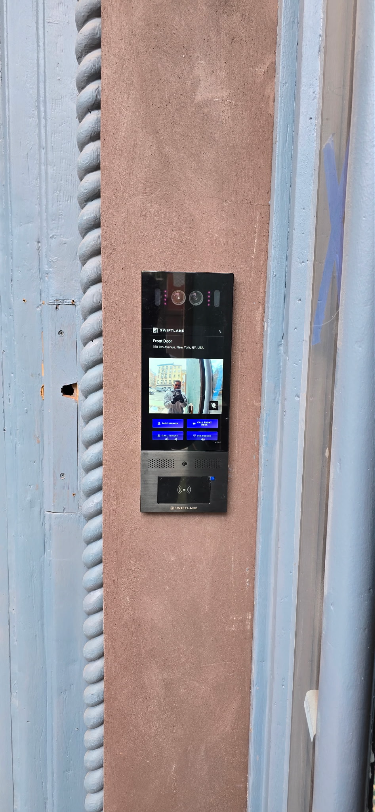Swiftlane smart video intercom system installed at a building entrance.