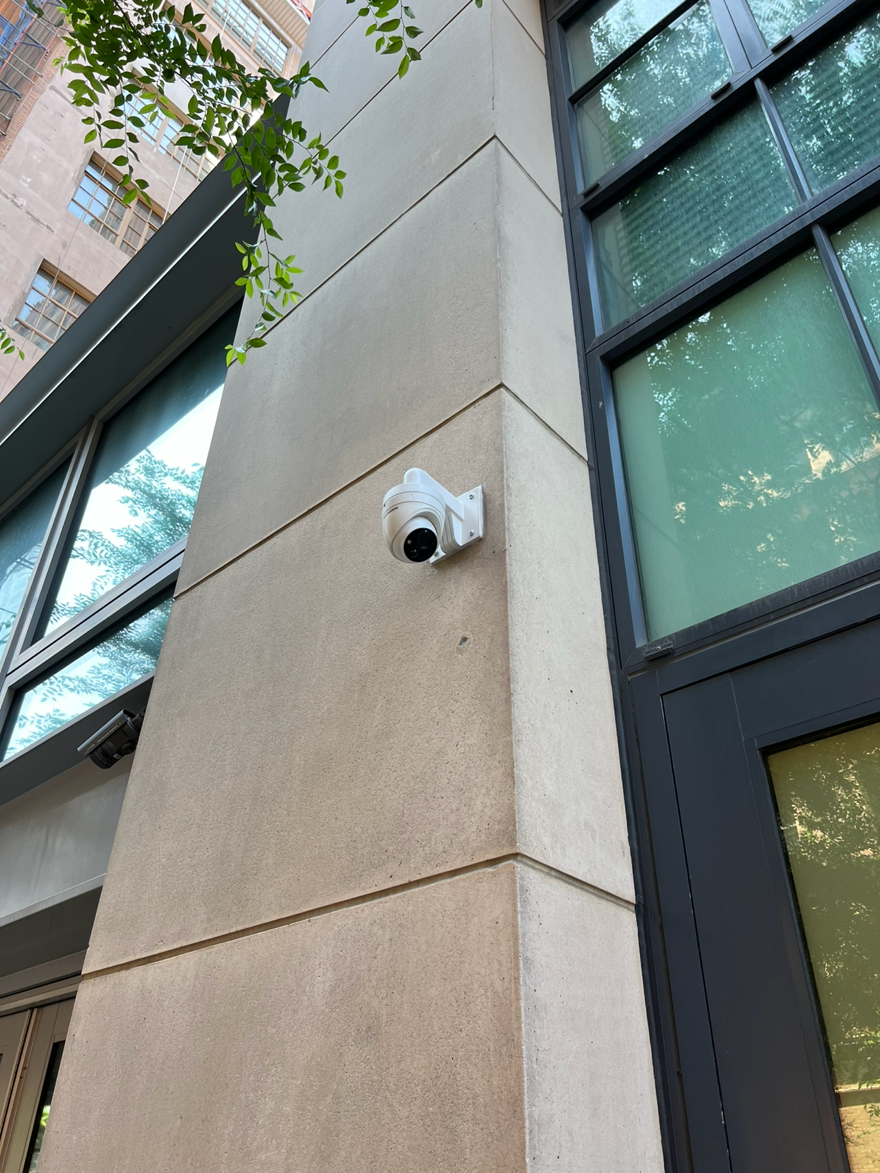 Outdoor commercial security camera system installed on a modern building facade.