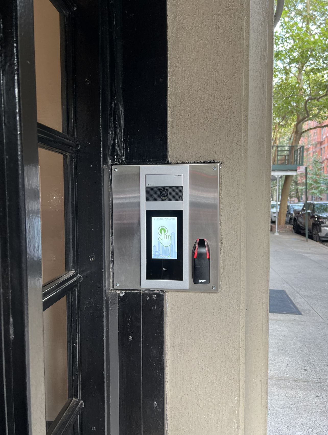 Comelit PAC access control system installed at the entrance of a residential building in Manhattan.