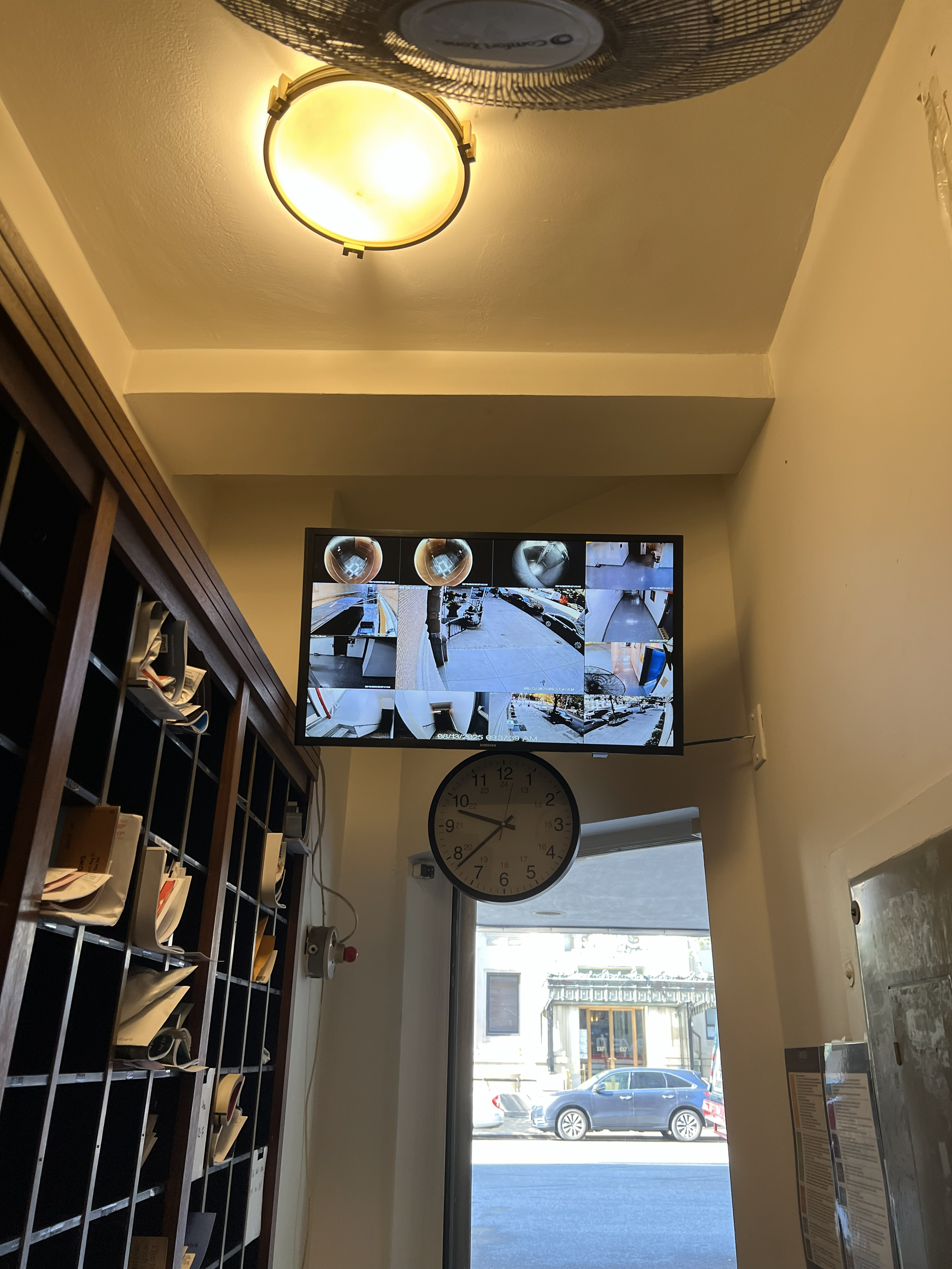 Central monitoring setup with large display showing live security camera footage for enhanced property oversight.