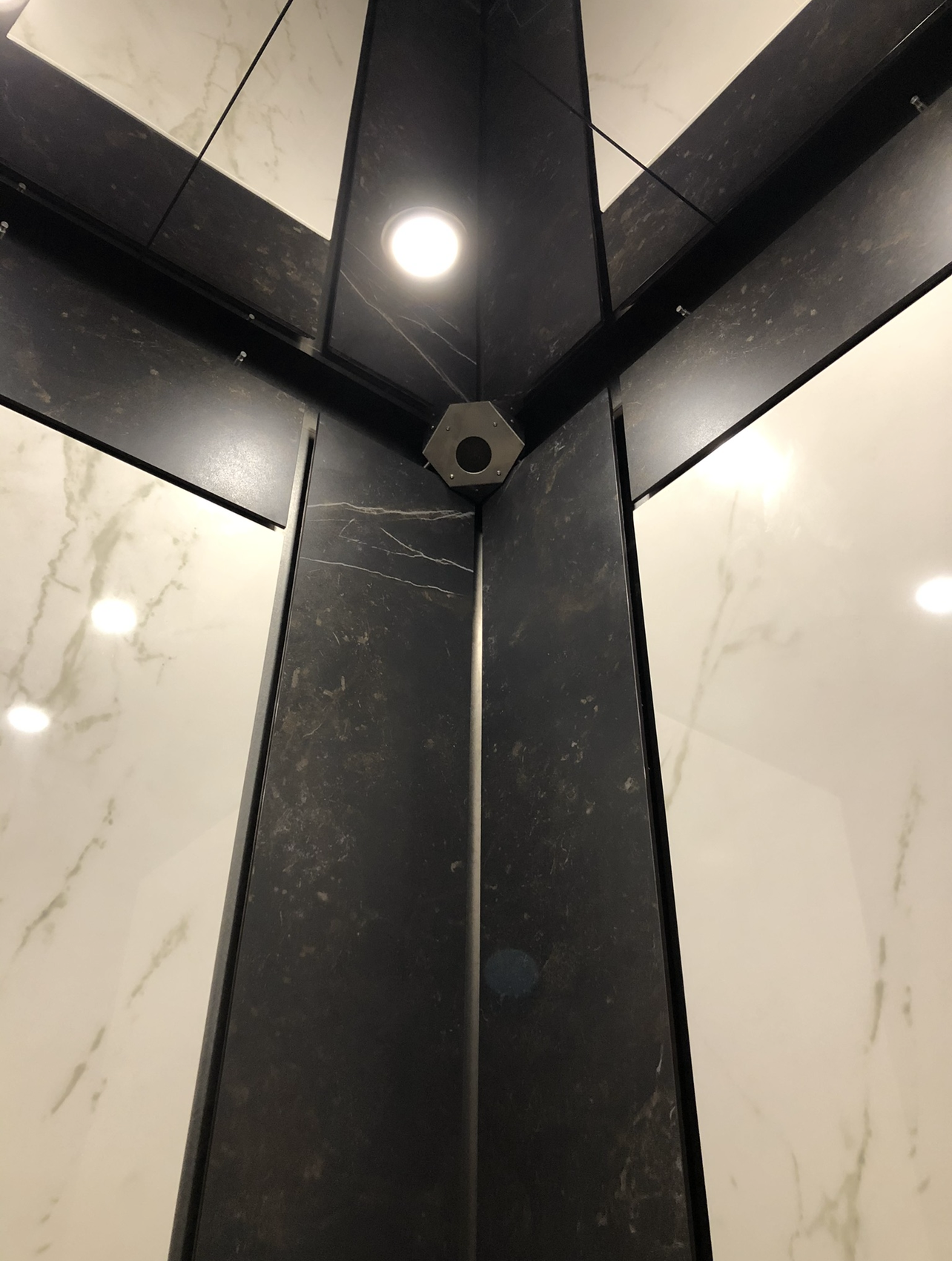 Discretely mounted elevator security camera installation in a luxury property.
