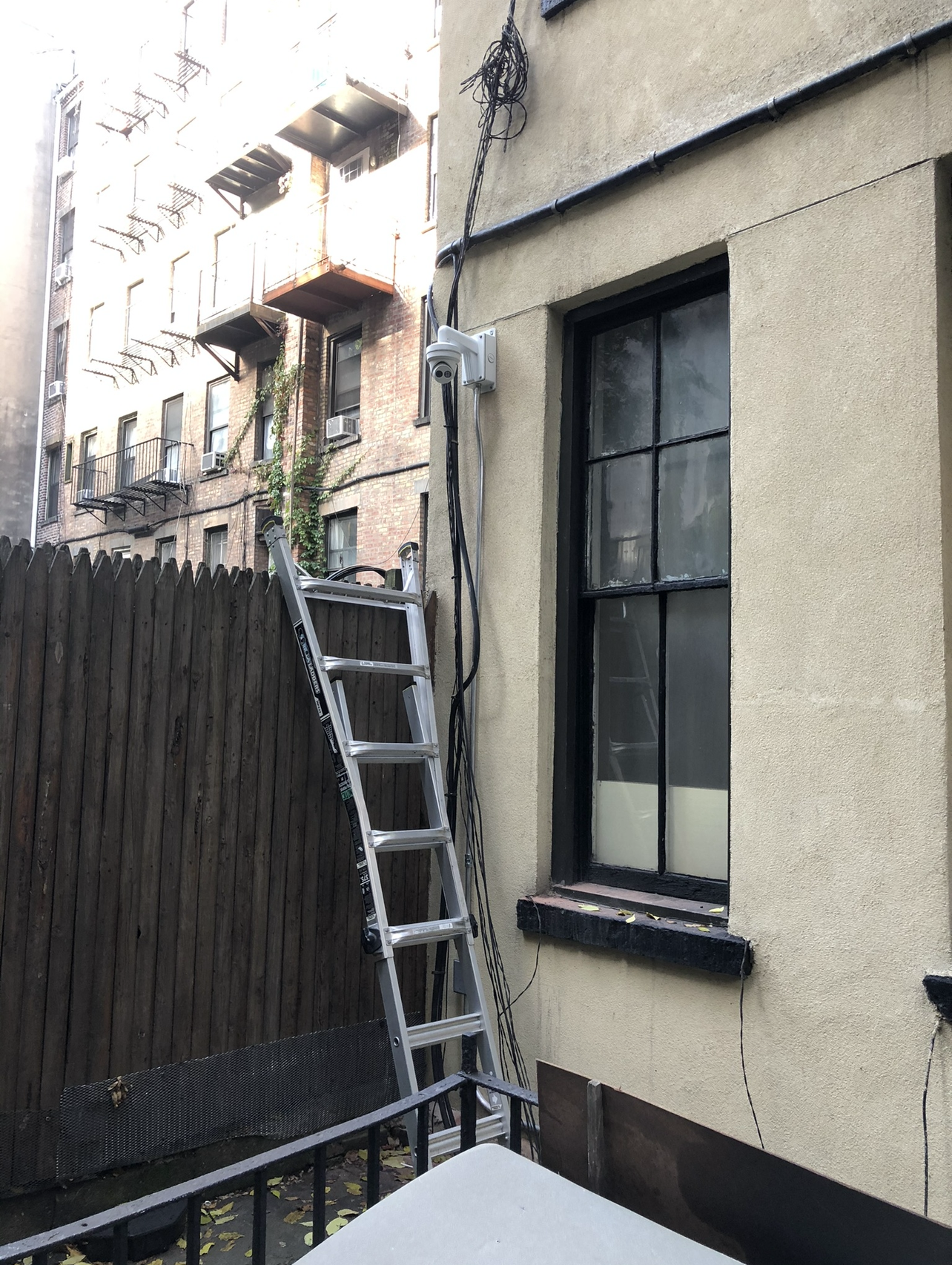 Outdoor security camera installed in a backyard for perimeter protection in NYC - Impera Security Systems. 