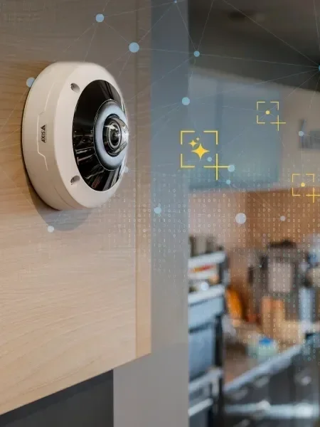 A security camera mounted on a wall inside a building.