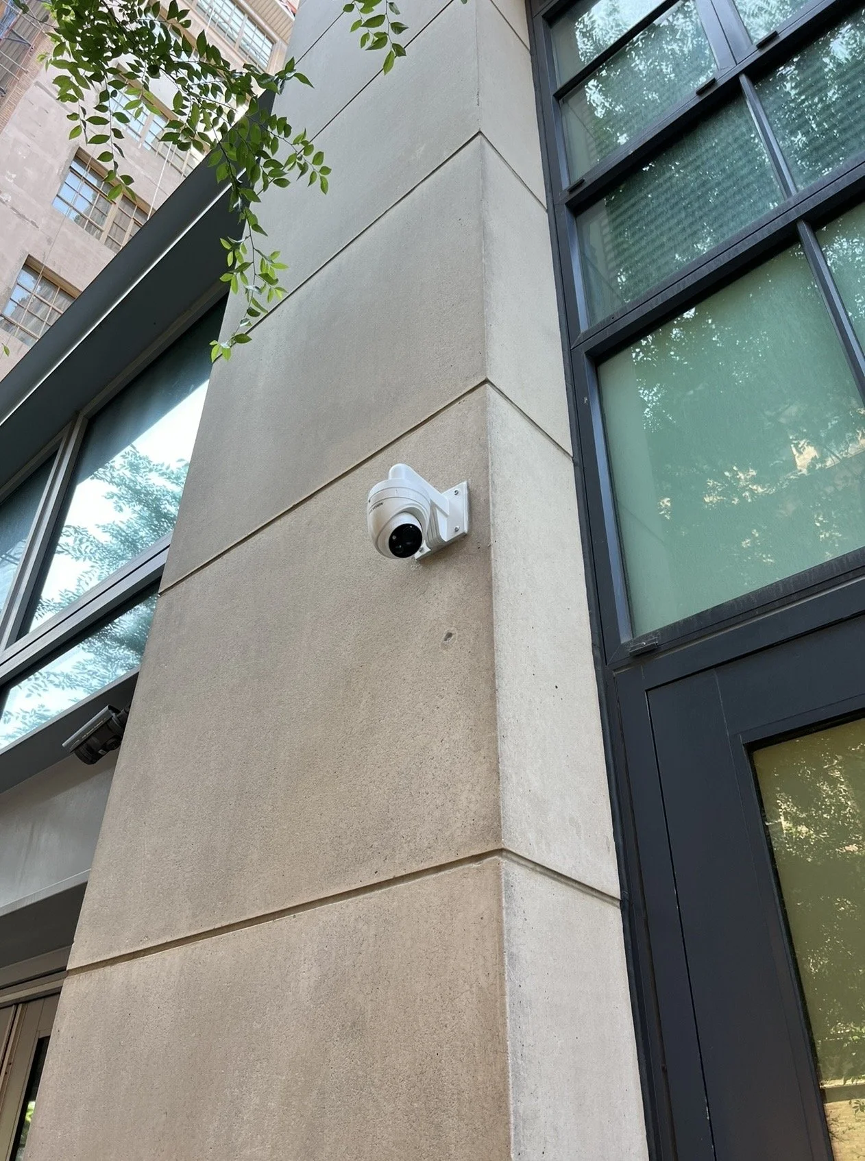 Commercial security camera installation on building exterior in New York City.