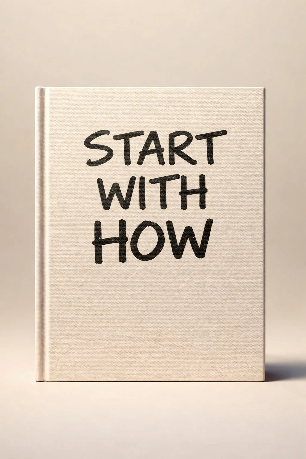 A beige book with black handwritten text that says, "Start with how" against a plain background.
