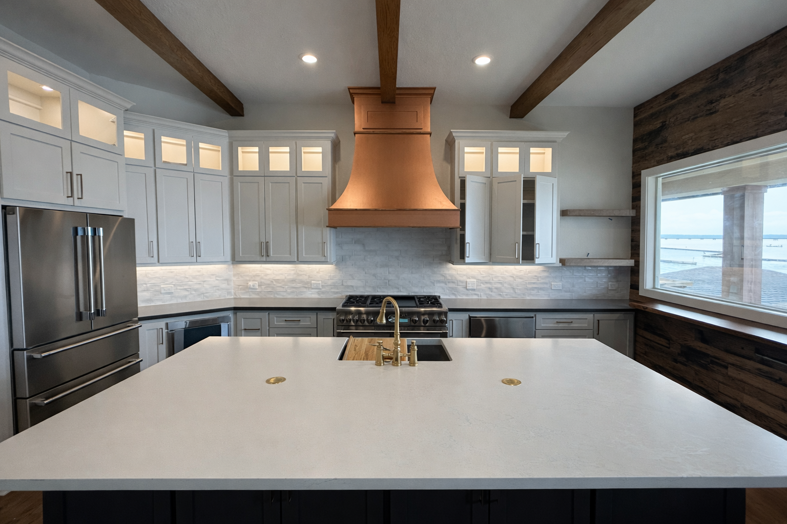 Modern kitchen with white cabinets, stainless steel refrigerator, brass sink faucet, and large window overlooking outdoors, with a copper range hood and wooden beams on ceiling.