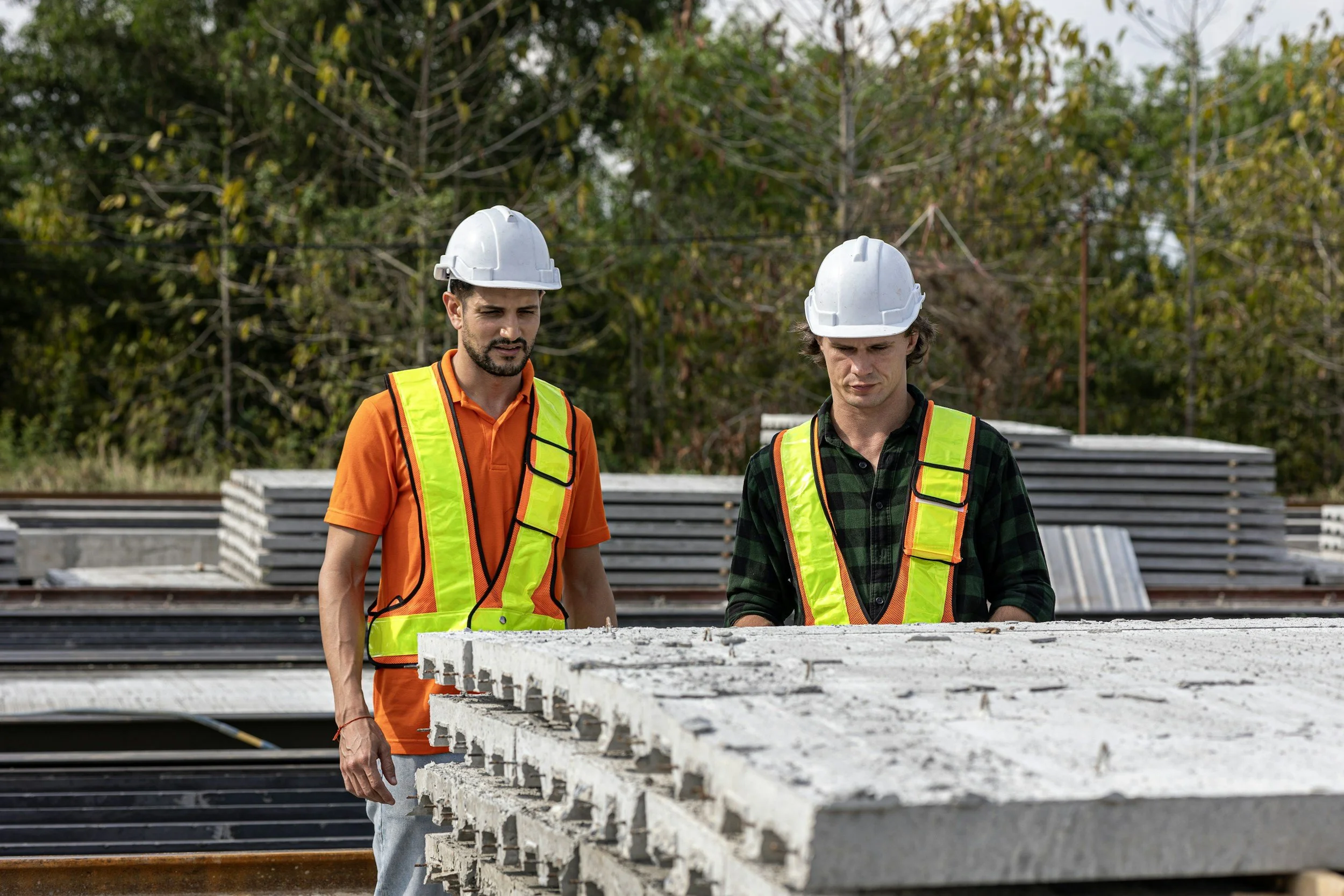wo site supervisors discussing ground protection and turf preservation solutions for an Austin construction and event site.
