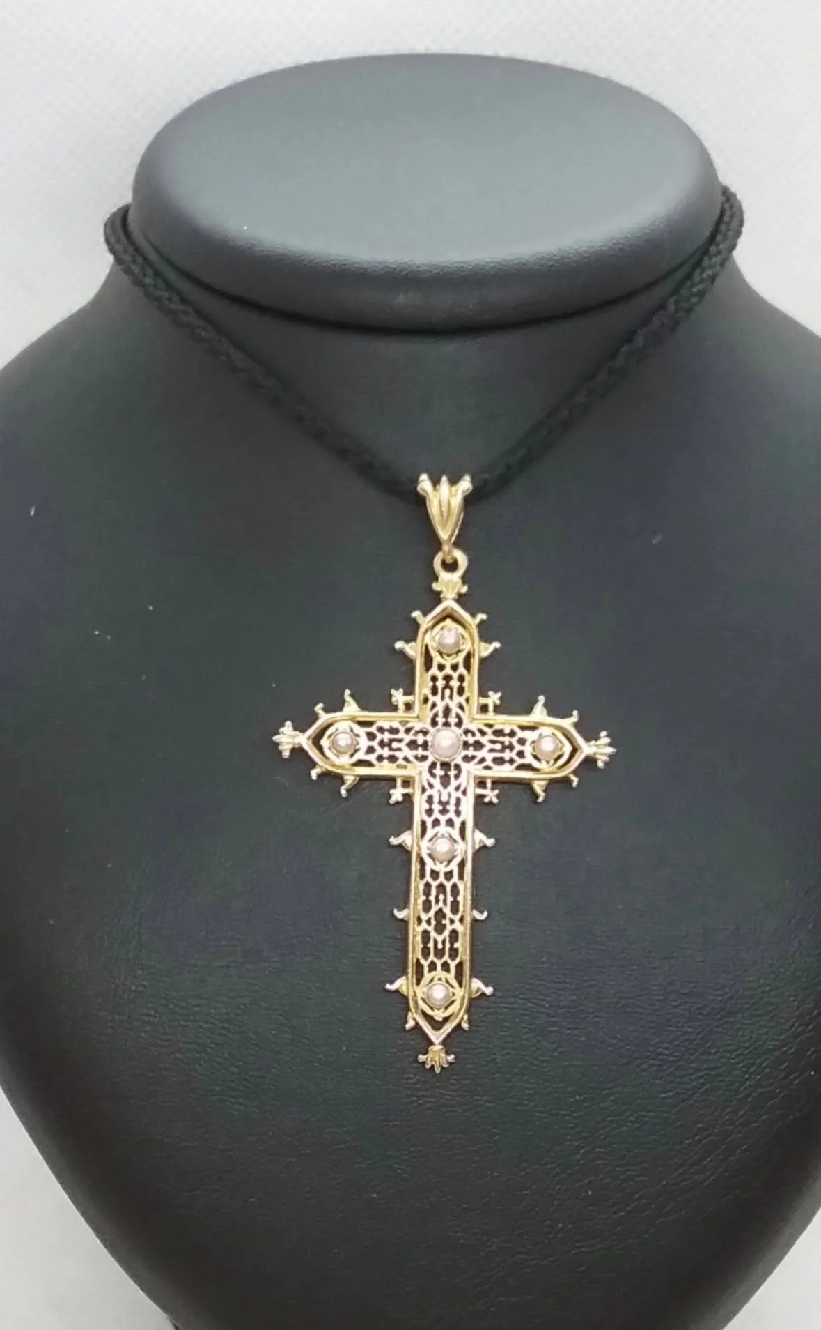Gold Estaing Cross pendant inspired by the cross on the medieval bridge in Estaing on the Via Podiensis pilgrimage route in France.
