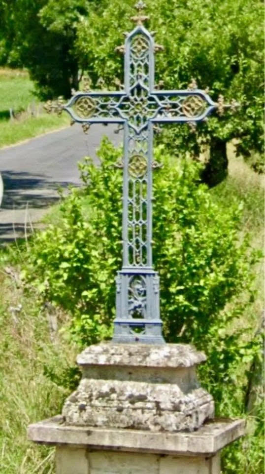 The original cast-iron Estaing Cross on the medieval bridge in Estaing before it was replaced in 1960.