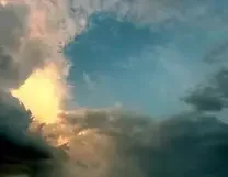 Cloudy sky with sunlight breaking through clouds