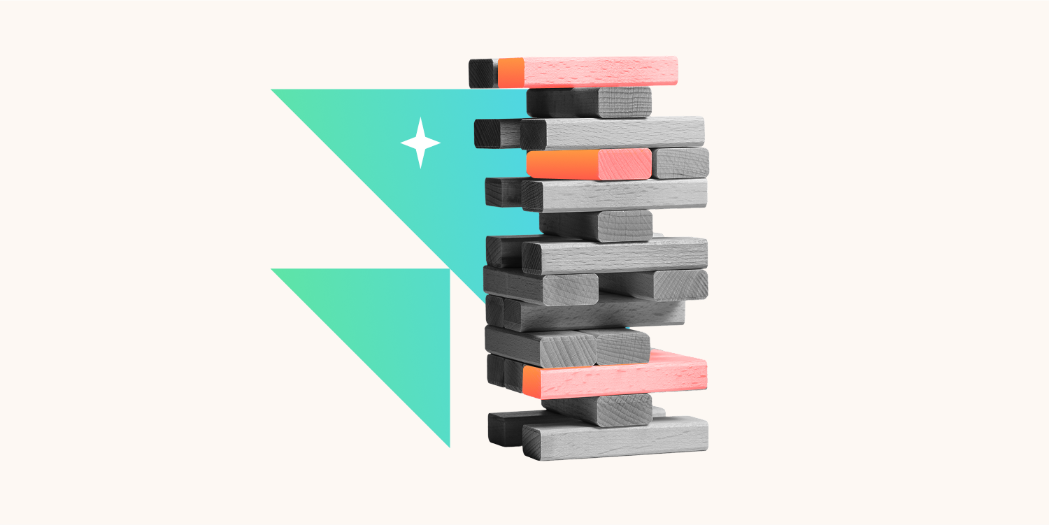 Stack of wooden blocks painted in black, gray, pink, and orange with a geometric background of teal and white.
