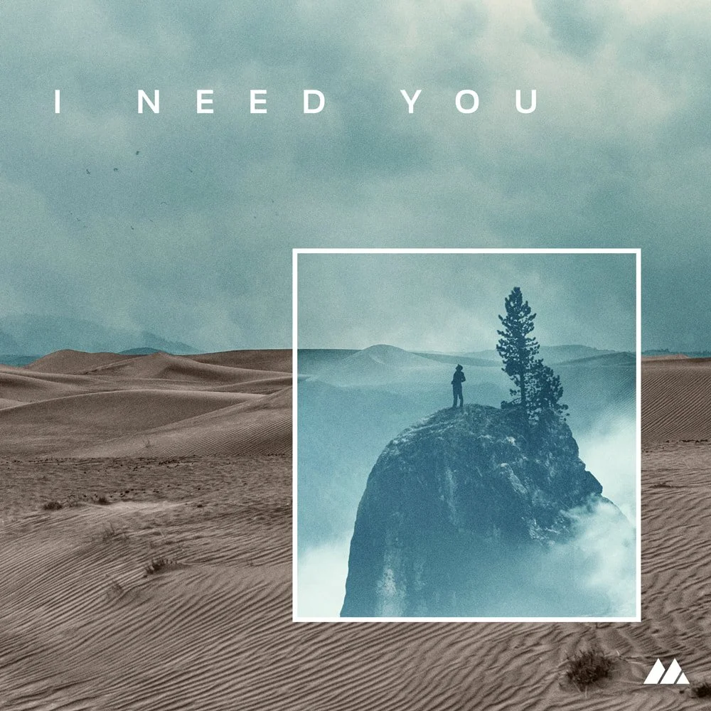 A desert landscape with sand dunes and a cloudy sky, featuring a smaller inset image of a person standing on a rocky cliff next to a tree, with fog or clouds surrounding the cliff.