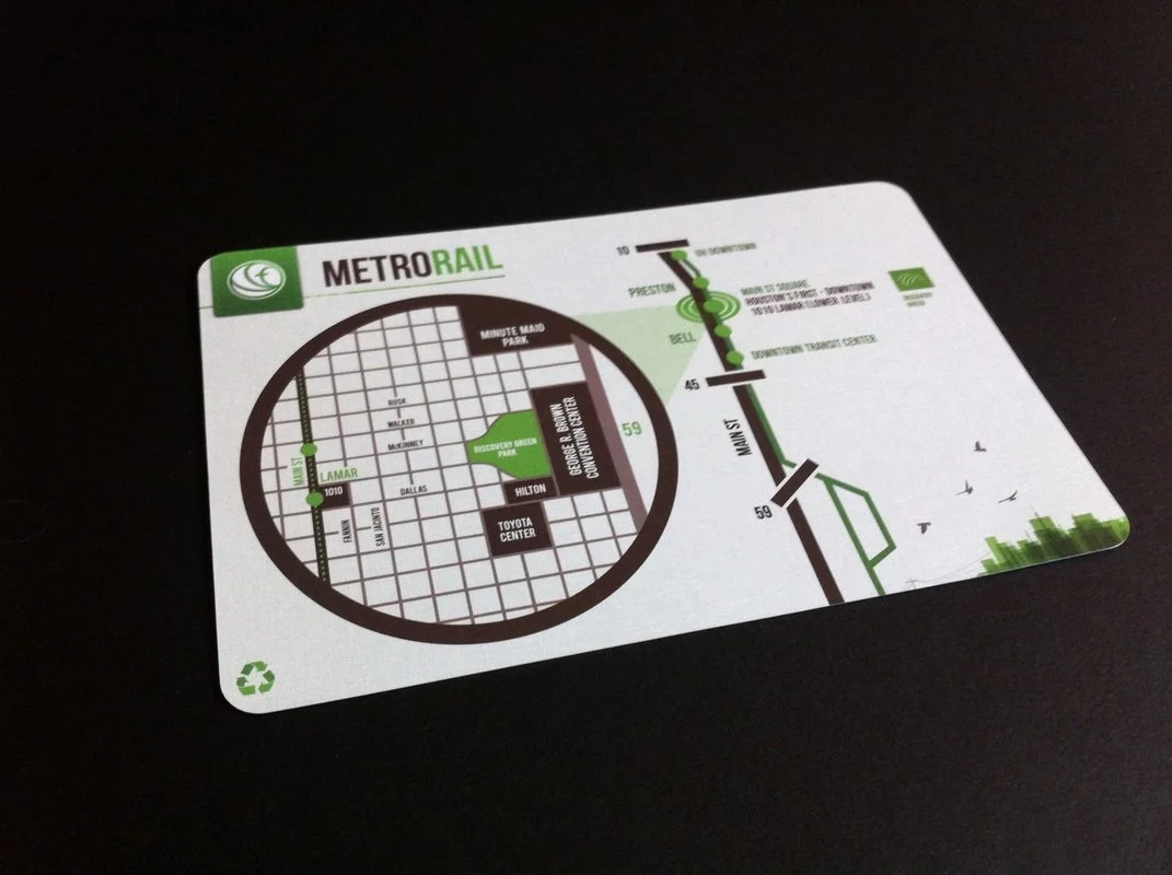 Metro Rail transit map showing station names and routes with green, black, and gray lines, including landmarks like Discovery Green Park and Toyota Center.