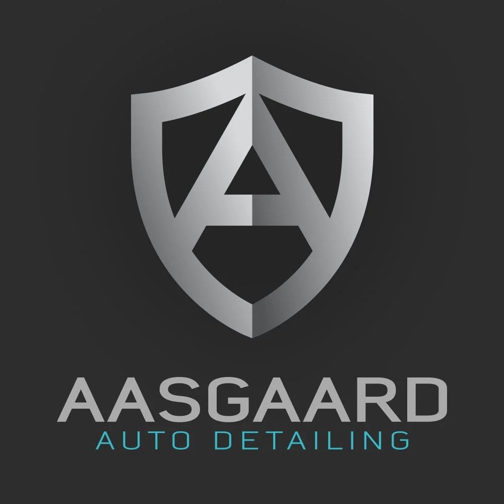 Logo of Aasgaard Auto Detailing featuring a silver shield with a stylized 'A' in the center and the company name 'Aasgaard Auto Detailing' written below, set against a dark background.