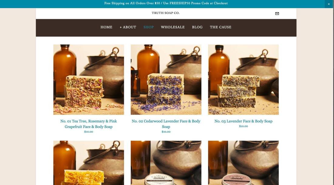 Online store page displaying various natural soap bars with ingredient names and prices, featuring bottles and vintage containers in the background.