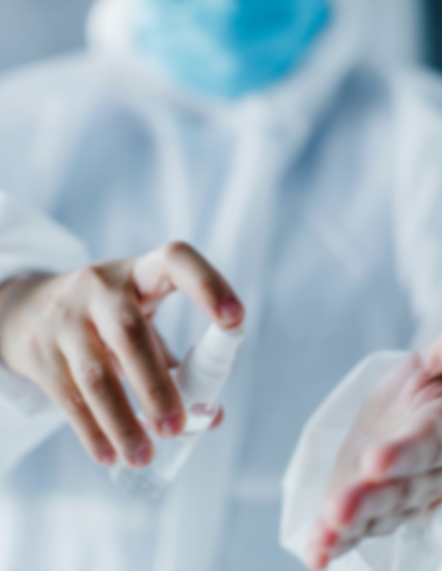 Healthcare professional using hand sanitizer, wearing a mask and practicing safe infection control
