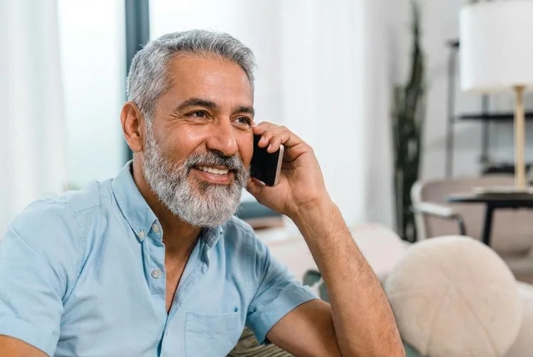 Senior man talks on smartphone