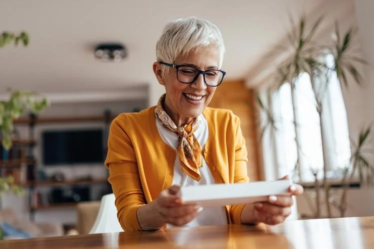 Senior woman gladly reads letter