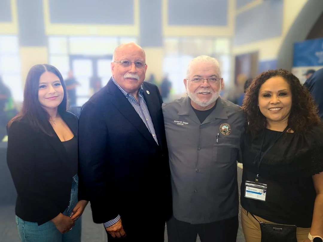 Four people interlock arms at a resource fair.