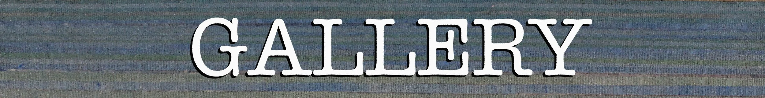 Sign with the word 'GALLERY' in white letters on a blue, green, and purple background.