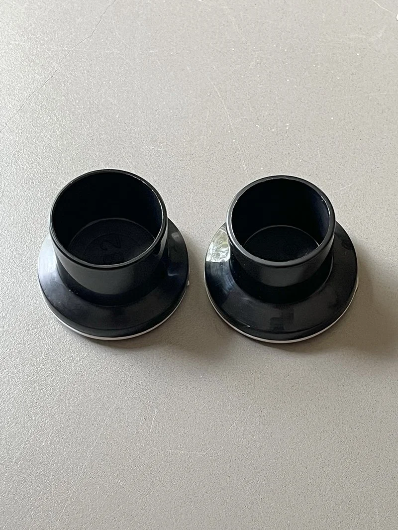 A pair of PortaGlory tension rod replacement end caps overhead view