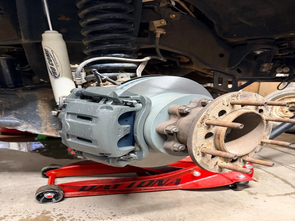 Truck brake repair in Springtown TX with new rotor and caliper installed at Anchor Automotive.