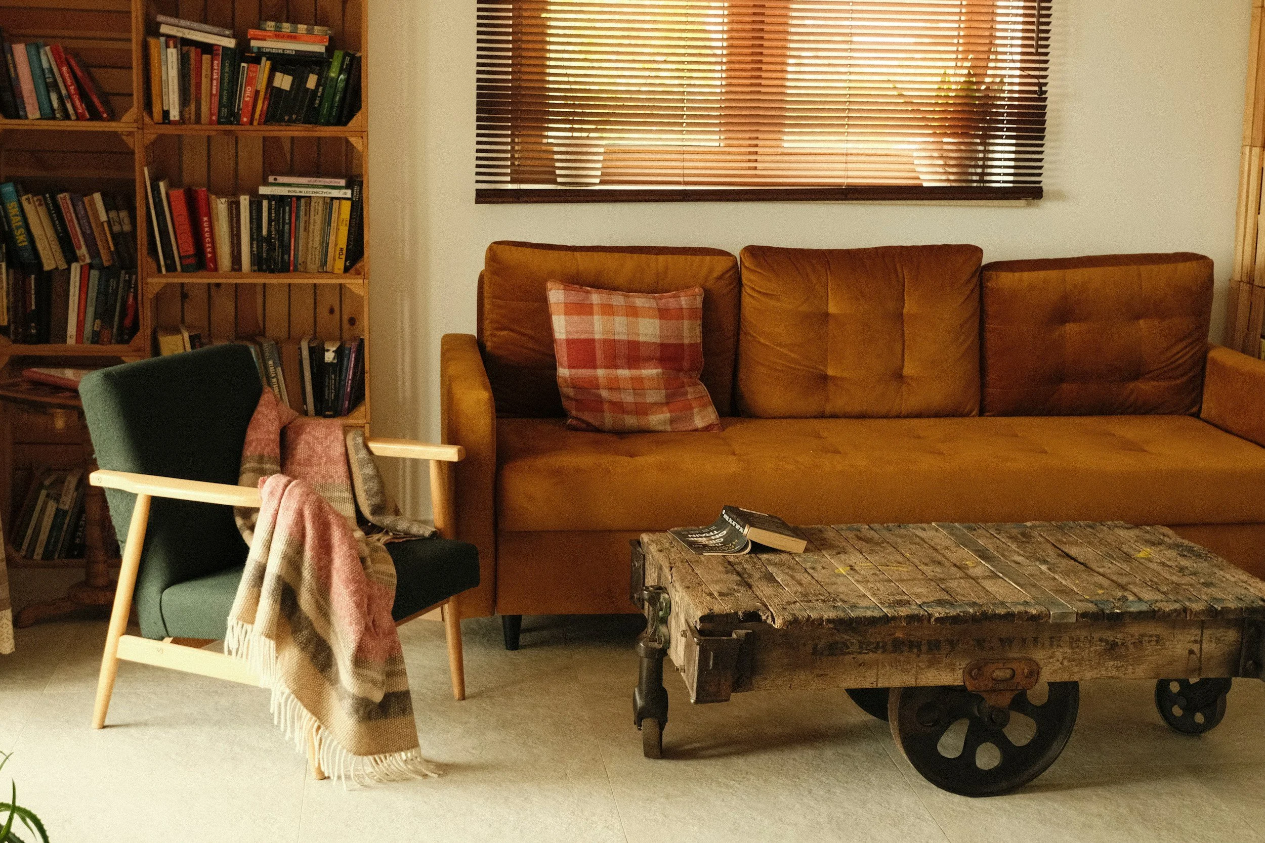 junk furniture, a couch, chair, and table, as well as an old bookshelf.
