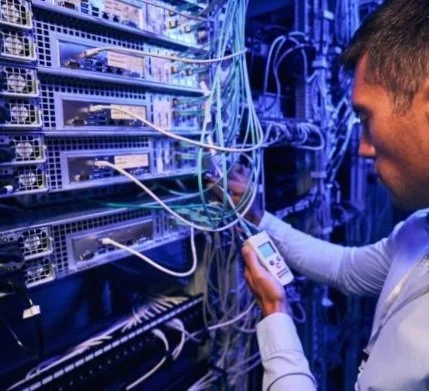 Technician working on a networking in a data center.