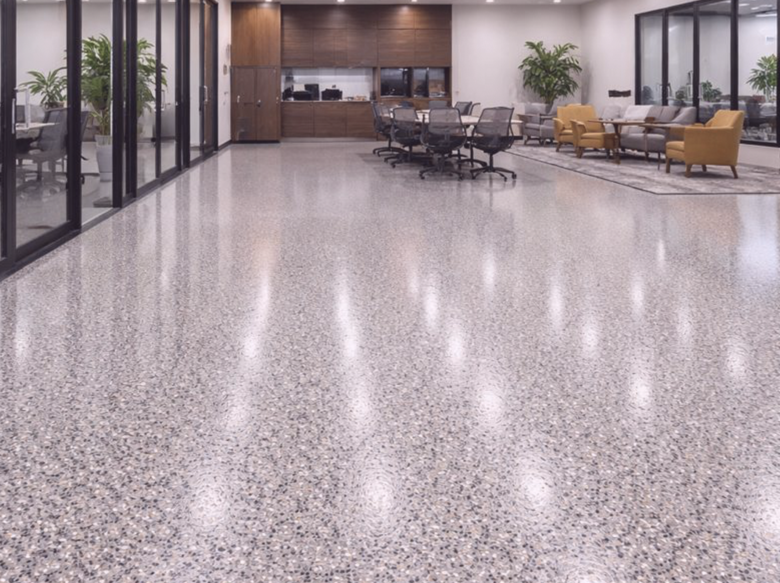 modern office lounge area with glass walls, full chip epoxy floor 