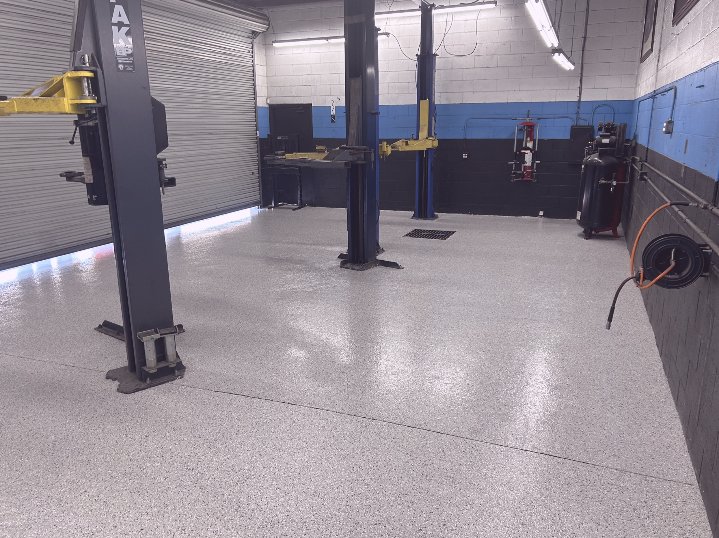 auto repair shop with updated sealed concrete epoxy floor full chip system