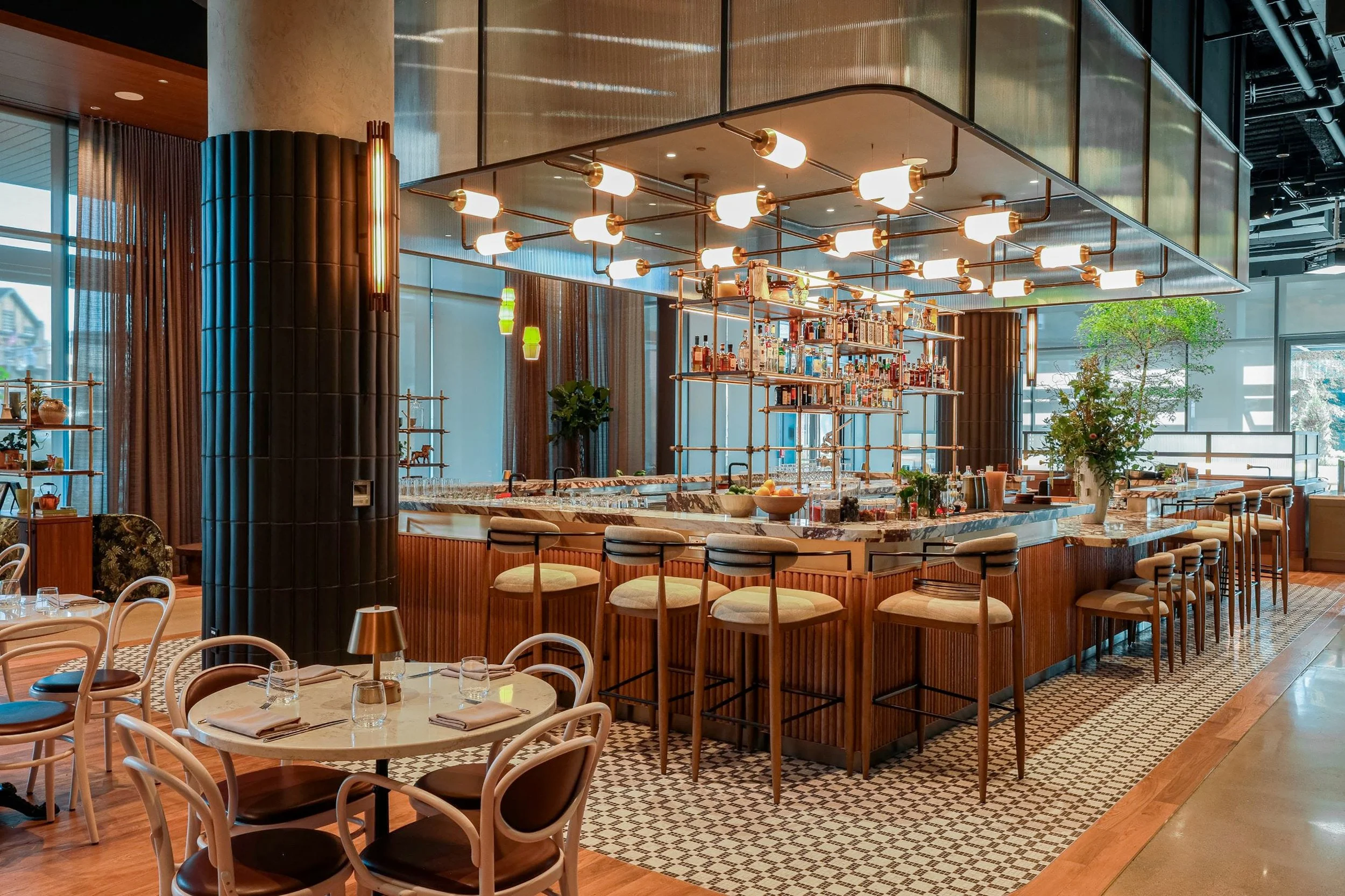 A bar layout at Morris Proper with lighting and chairs designed by Davella Studios.