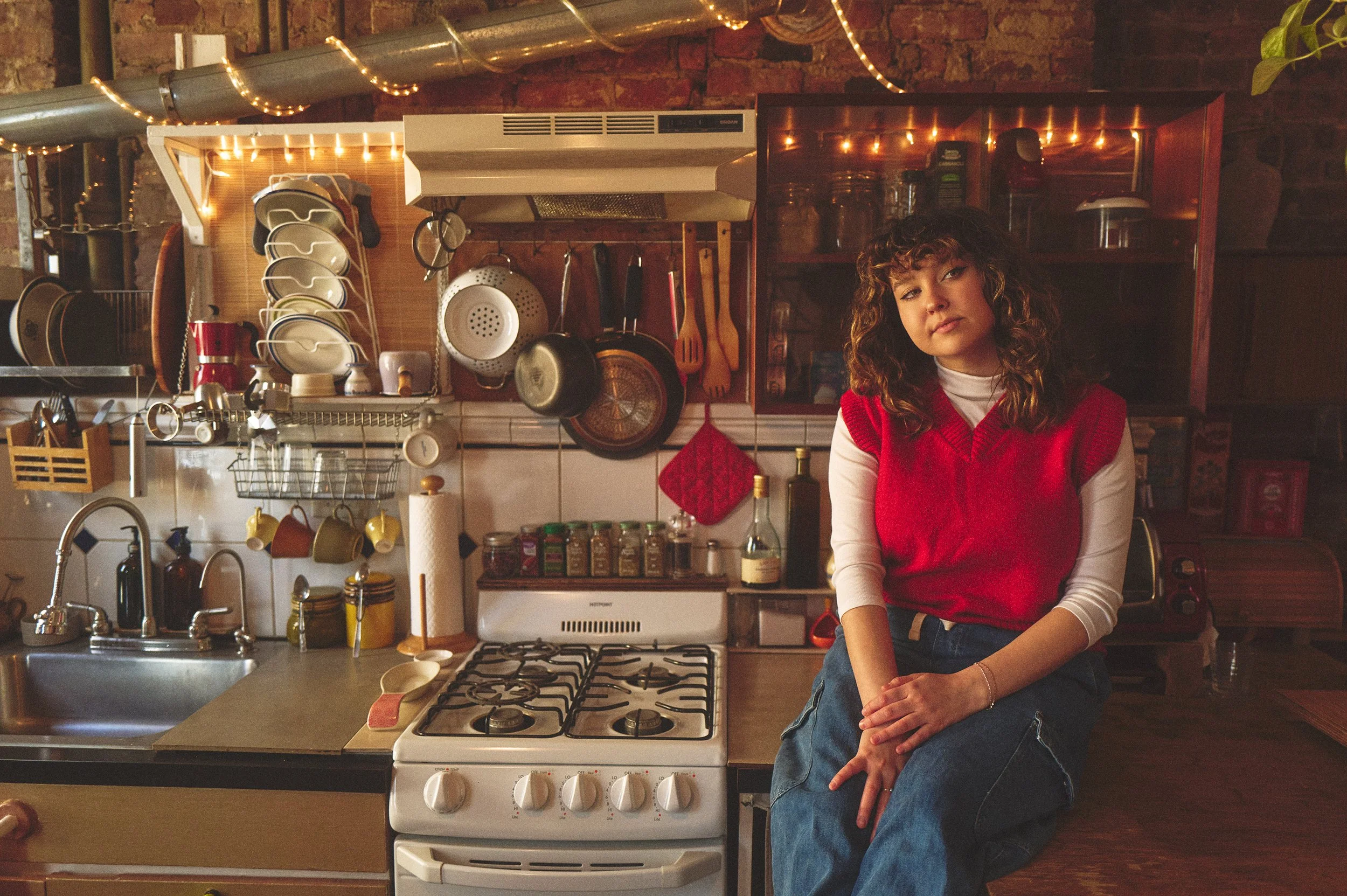 Portrait of Ellie Fern seated in a cozy kitchen, alternative indie artist based in New York City