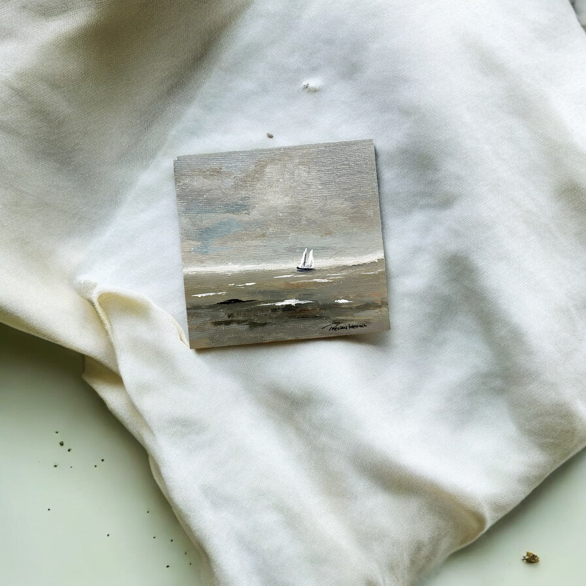 Miniature landscape painting of a sailboat on the water with a cloudy sky, signed in the bottom right corner.