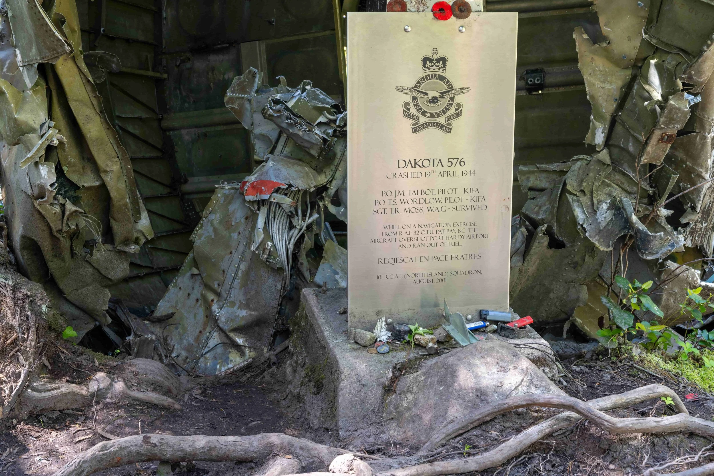 Dakota 576 crash memorial surrounded by aircraft wreckage in Vancouver Island forest